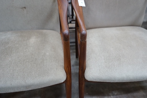 A pair of mid century teak upholstered elbow chairs, width 54cm, depth 63cm, height 84cm